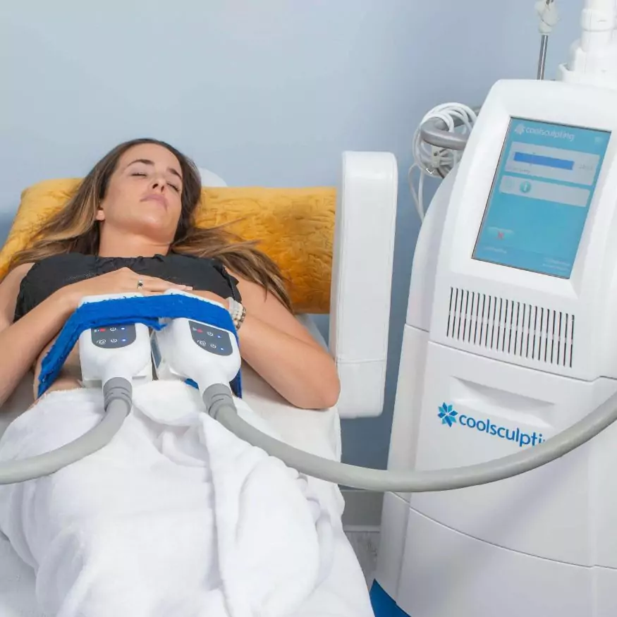 A woman patient undergoing a coolsculpting treatment.